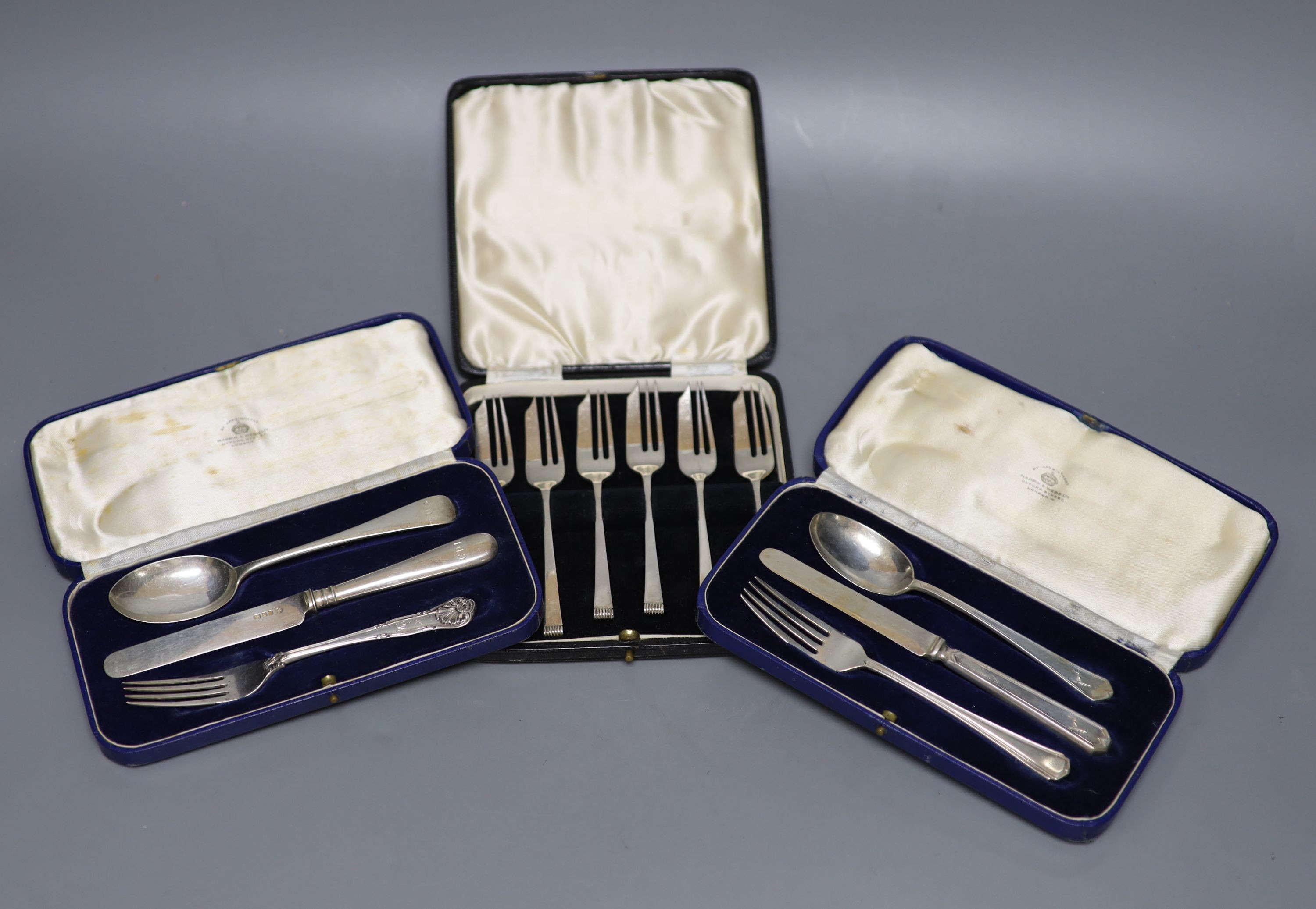 A cased set of six Art Deco silver cake forks, Sheffield, 1936 and two cased silver christening trios.